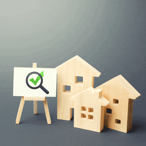 Residential buildings and easel with magnifying glass and green check mark. 