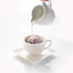 Milk being poured over Hot Chocolate Bombe