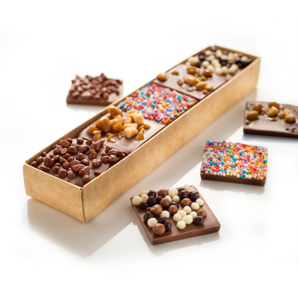 Belgian milk chocolate squares decorated with a variety of sweet toppings.