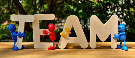 A photo of wooden letters, spelling out the word team